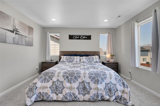 bedroom featuring carpet floors and multiple windows