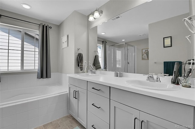 bathroom with tile patterned floors, vanity, and separate shower and tub