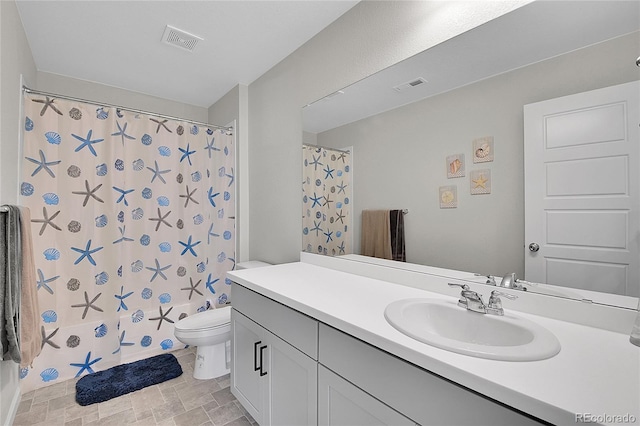 bathroom with toilet and vanity