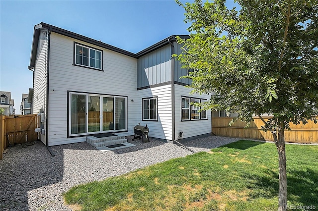 back of property featuring a patio area and a yard