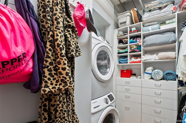 clothes washing area featuring stacked washer / drying machine