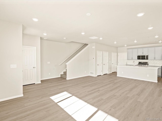 unfurnished living room featuring light wood-type flooring