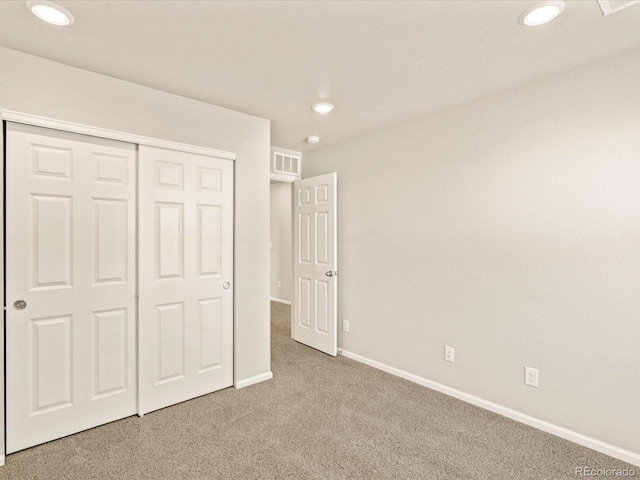 unfurnished bedroom with carpet flooring and a closet