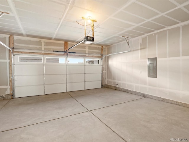 garage with a garage door opener and electric panel