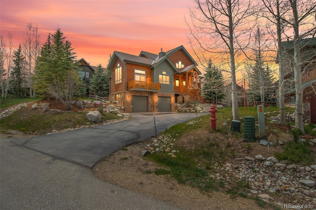56 Canyon View Ct, Dillon, CO 80435 - chalet / cabin with a garage, asphalt driveway, and stone siding
