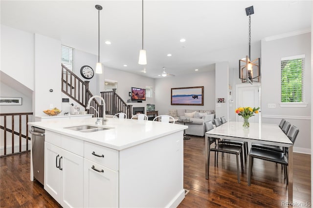 8768 E 54th Pl, Denver, CO 80238 - kitchen featuring a sink, stainless steel dishwasher, dark wood finished floors, an island with sink, and recessed lighting