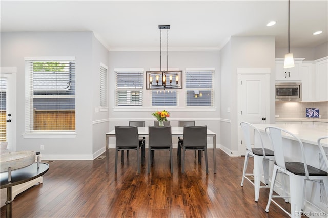 8768 E 54th Pl, Denver, CO 80238 - dining space featuring a chandelier, dark wood-style floors, baseboards, ornamental molding, and recessed lighting