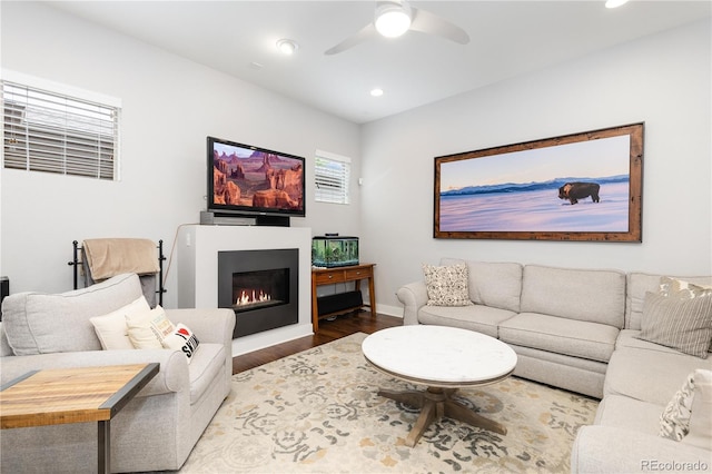 8768 E 54th Pl, Denver, CO 80238 - living room featuring wood finished floors, recessed lighting, a ceiling fan, baseboards, and a glass covered fireplace