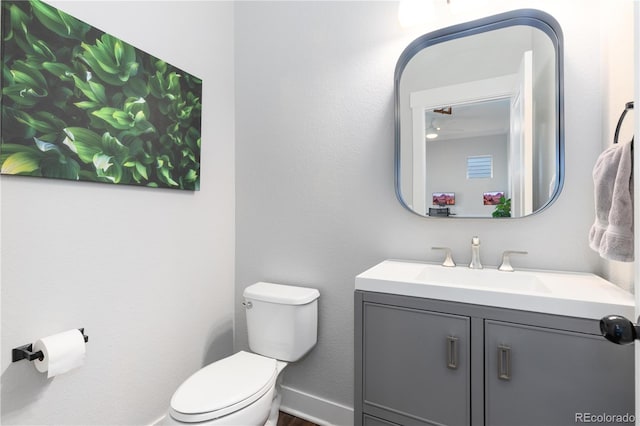 8768 E 54th Pl, Denver, CO 80238 - bathroom featuring toilet, vanity, and baseboards