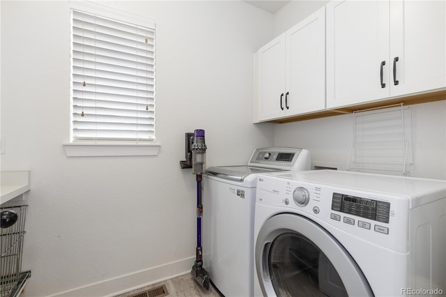 8768 E 54th Pl, Denver, CO 80238 - washroom featuring cabinet space, washing machine and dryer, baseboards, and light wood-style floors