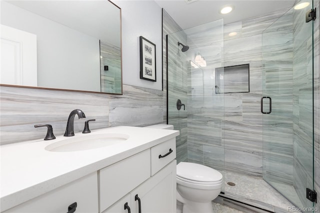8768 E 54th Pl, Denver, CO 80238 - bathroom with tile walls, vanity, toilet, a shower stall, and recessed lighting