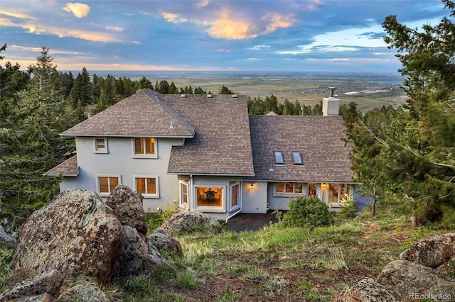 9001 Eastridge Rd, Golden, CO 80403 - view of front of house with a shingled roof and stucco siding