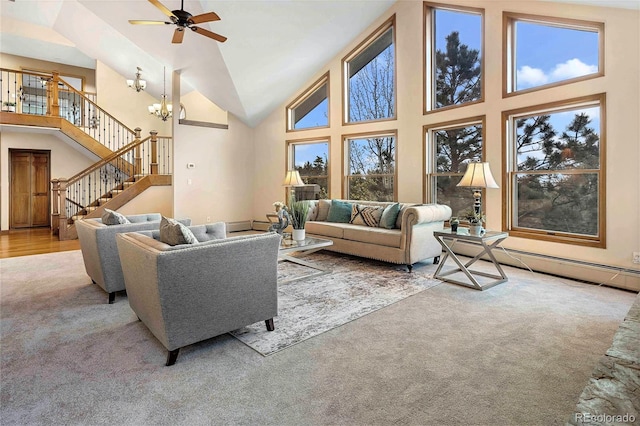 9001 Eastridge Rd, Golden, CO 80403 - living room featuring carpet floors, high vaulted ceiling, a ceiling fan, stairs, and a chandelier