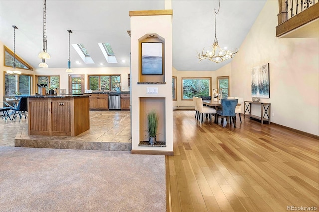 9001 Eastridge Rd, Golden, CO 80403 - kitchen featuring stainless steel dishwasher, high vaulted ceiling, a chandelier, a kitchen island, and dark countertops