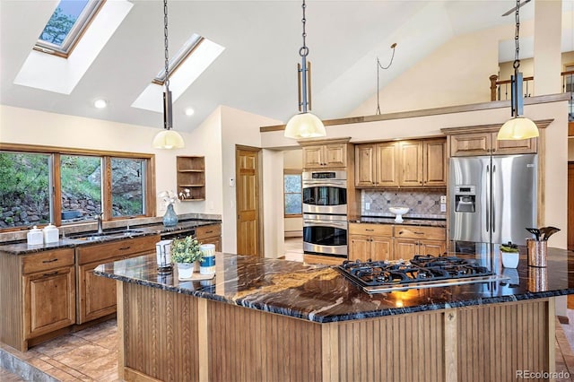9001 Eastridge Rd, Golden, CO 80403 - kitchen featuring stainless steel appliances, a sink, a skylight, backsplash, and dark stone counters
