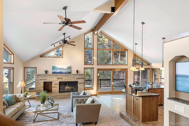 9001 Eastridge Rd, Golden, CO 80403 - living area featuring high vaulted ceiling, a fireplace, ceiling fan, and beamed ceiling