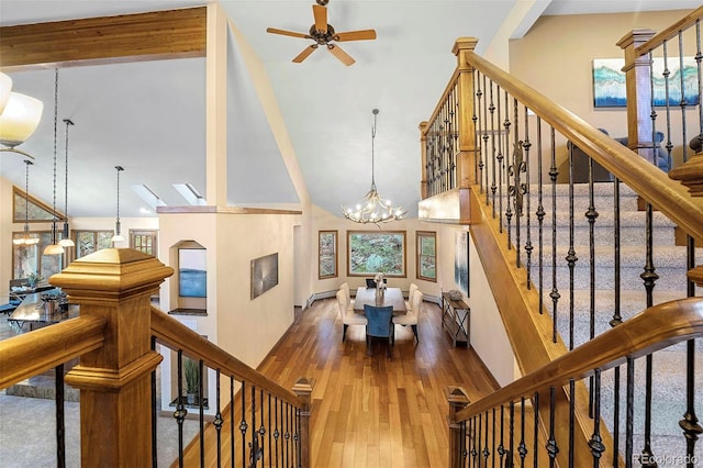 9001 Eastridge Rd, Golden, CO 80403 - living area featuring high vaulted ceiling, a chandelier, hardwood / wood-style floors, a ceiling fan, and stairway