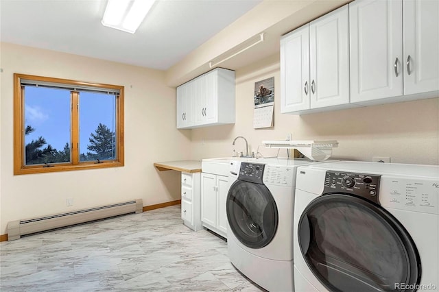 9001 Eastridge Rd, Golden, CO 80403 - laundry area featuring a baseboard heating unit, light marble finish flooring, cabinet space, washer and dryer, and baseboards