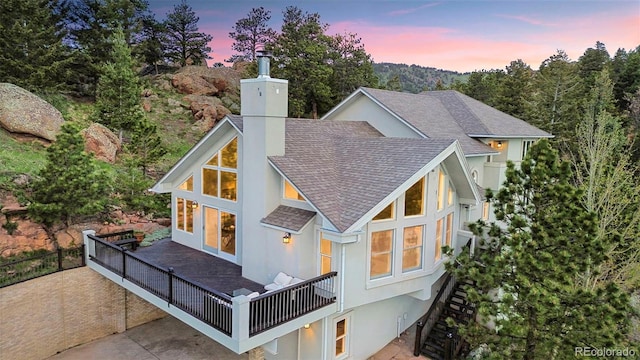 9001 Eastridge Rd, Golden, CO 80403 - rear view of house with a chimney and a shingled roof