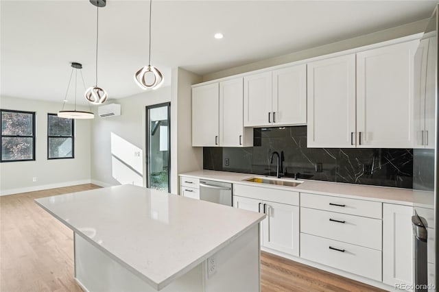 1559 N Hooker St, Denver, CO 80204 - kitchen featuring stainless steel dishwasher, a wall mounted air conditioner, light wood-style flooring, tasteful backsplash, and recessed lighting