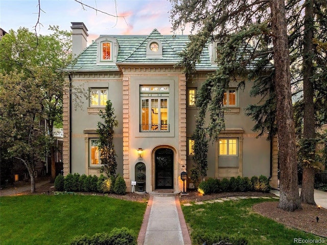 165 N High St, Denver, CO 80218 - view of front facade featuring a chimney, a front lawn, and stucco siding