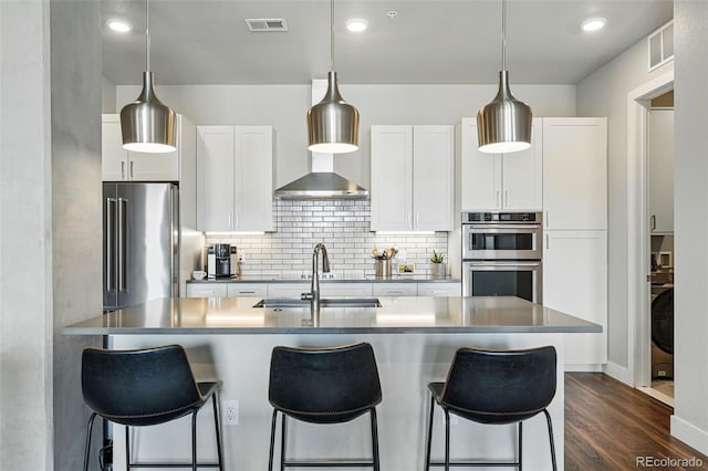 20 Wilcox St Unit 208, Castle Rock, CO 80104 - kitchen with stainless steel appliances, a breakfast bar area, white cabinetry, and recessed lighting