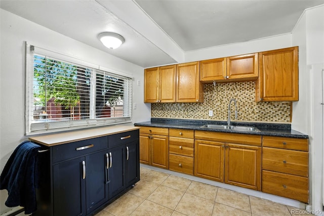 613 S Union Blvd, Colorado Springs, CO 80910 - kitchen with brown cabinets, decorative backsplash, light tile patterned flooring, and dark countertops