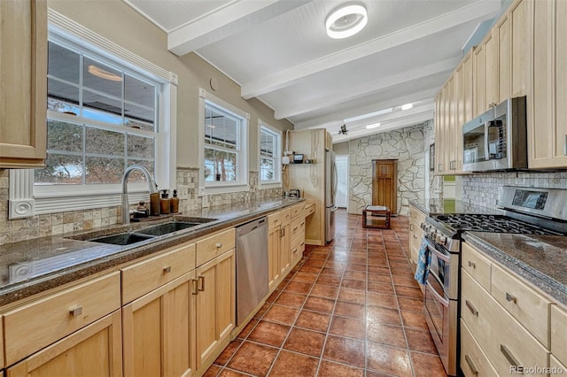 kitchen featuring backsplash, sink, beamed ceiling, and appliances with stainless steel finishes