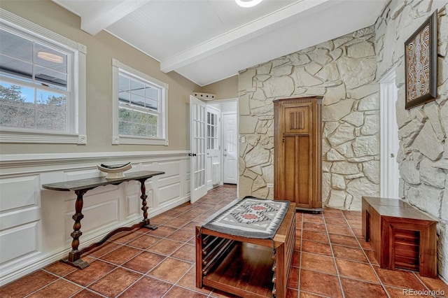 interior space featuring beam ceiling and dark tile patterned floors