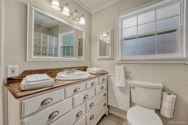 bathroom featuring tile patterned flooring, vanity, plenty of natural light, and ornamental molding