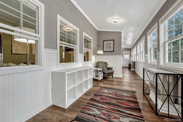 hallway with dark hardwood / wood-style floors, vaulted ceiling, and ornamental molding