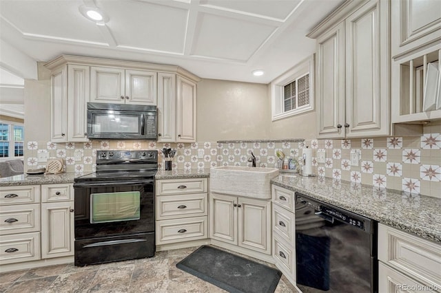 kitchen with black appliances, tasteful backsplash, sink, and cream cabinets