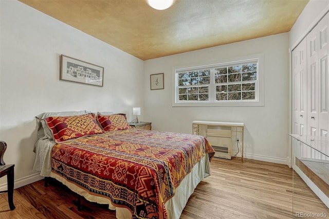 bedroom featuring light wood-type flooring and a closet