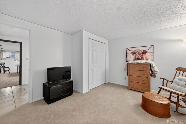3070 W Enchanted Cir, Colorado Springs, CO 80917 - living area with carpet flooring, a textured ceiling, baseboards, and tile patterned flooring