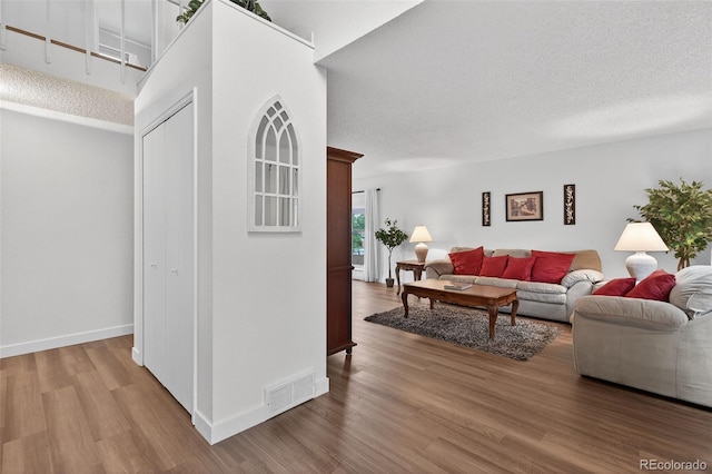 3070 W Enchanted Cir, Colorado Springs, CO 80917 - living area with wood finished floors, baseboards, and a textured ceiling