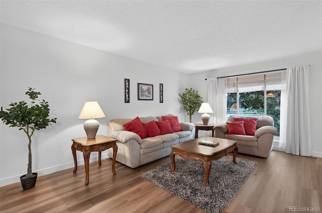 3070 W Enchanted Cir, Colorado Springs, CO 80917 - living area with a textured ceiling, wood finished floors, and baseboards