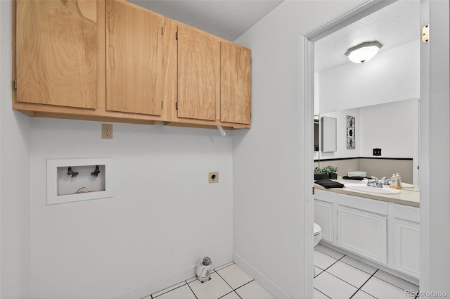3070 W Enchanted Cir, Colorado Springs, CO 80917 - laundry area with hookup for a washing machine, light tile patterned flooring, hookup for an electric dryer, baseboards, and cabinet space