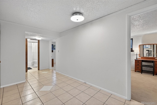 3070 W Enchanted Cir, Colorado Springs, CO 80917 - spare room featuring a textured ceiling, light tile patterned flooring, and baseboards