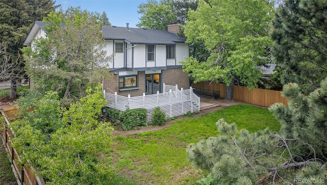 3070 W Enchanted Cir, Colorado Springs, CO 80917 - back of house featuring a chimney, brick siding, and a shingled roof