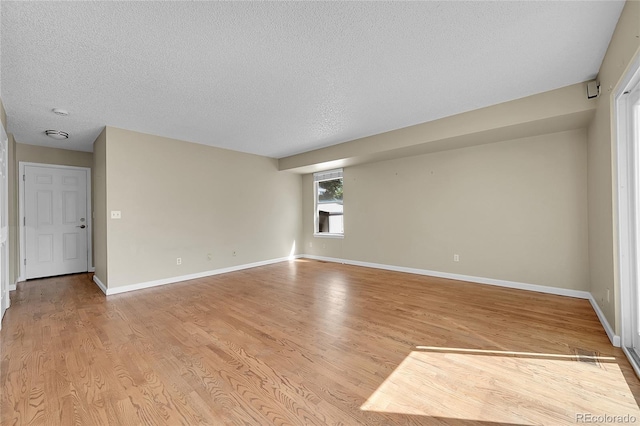 9008 W 101st Ave, Broomfield, CO 80021 - empty room featuring a textured ceiling and light wood-type flooring
