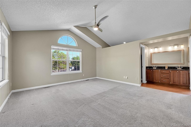 9008 W 101st Ave, Broomfield, CO 80021 - unfurnished bedroom with light colored carpet, a textured ceiling, ensuite bathroom, lofted ceiling, and ceiling fan