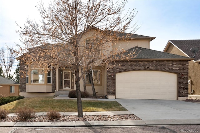 view of front of home featuring a front yard and a garage