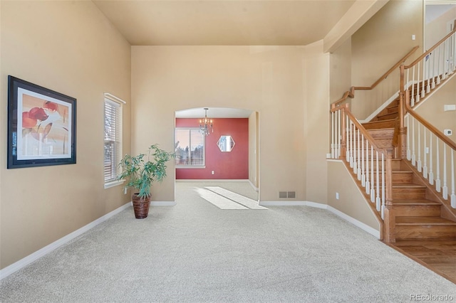 interior space featuring carpet floors and a chandelier