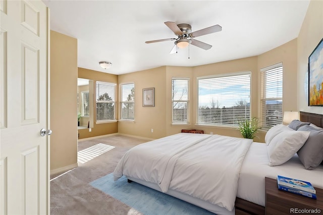 bedroom featuring ceiling fan and light colored carpet