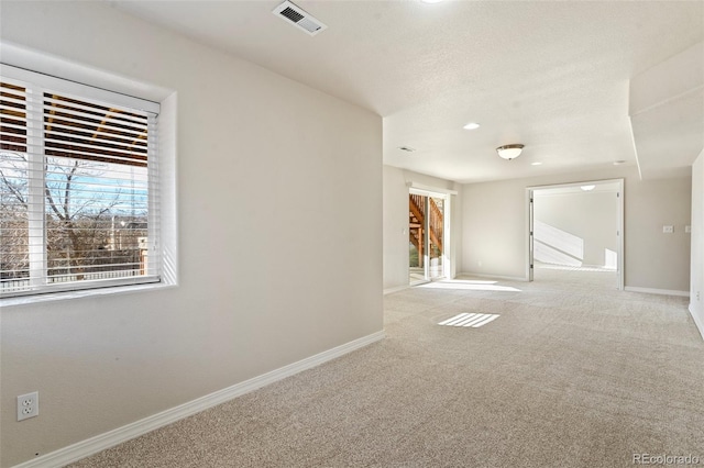 unfurnished room with light colored carpet