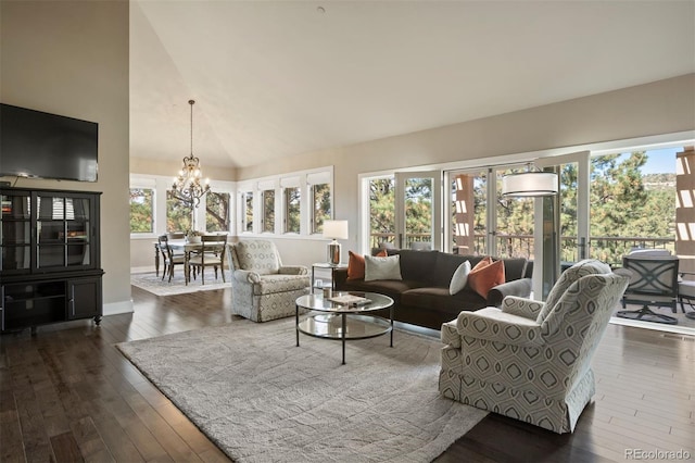 living room with an inviting chandelier, dark hardwood / wood-style floors, and a healthy amount of sunlight