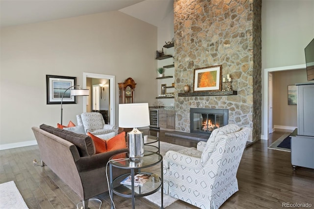 living room with a stone fireplace, dark hardwood / wood-style floors, high vaulted ceiling, and beverage cooler