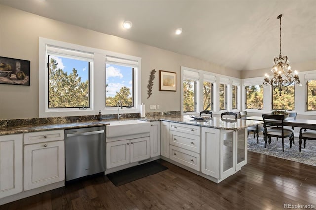 kitchen with kitchen peninsula, white cabinetry, stainless steel dishwasher, dark wood-type flooring, and sink