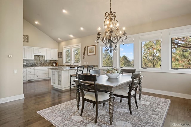 dining room with high vaulted ceiling, an inviting chandelier, and dark hardwood / wood-style floors