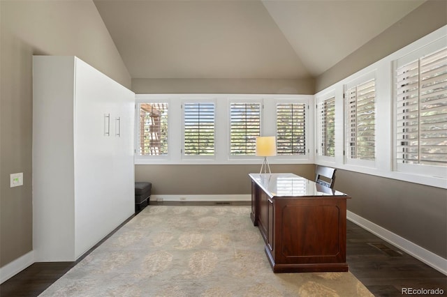 home office with lofted ceiling and light hardwood / wood-style floors